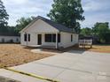 Charming home with white siding, new landscaping, and a spacious driveway at 2200 Clay St # 2, Kannapolis, NC 28083
