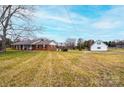 Expansive property showcasing the main house and a detached garage with ample yard space at 30 Hillsboro Rd, Taylorsville, NC 28681