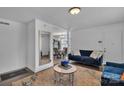 Open living room with hardwood floors, neutral walls, blue seating and view to dining room at 3036 Marlowe Ave, Charlotte, NC 28208