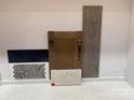 Interior design scheme showcasing wood and navy blue cabinet door samples with white marble countertop samples at 333 Basil Dr, Indian Trail, NC 28079