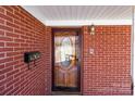 Close-up of the front entrance featuring a decorative glass door, brick facade, and stylish mailbox at 407 Pinecroft Ln, Spencer, NC 28159