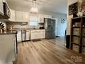 Bright kitchen with stainless steel appliances, ample cabinet space, and wood-look flooring at 409 Fourth St, York, SC 29745