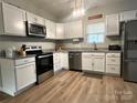 Modern kitchen featuring stainless steel appliances, white cabinets, and granite countertops at 409 Fourth St, York, SC 29745