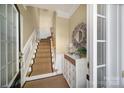 Entryway with staircase, decorated console table, and charming details at 44421 Oriole Dr # 203, Indian Land, SC 29707