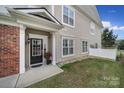 Inviting front entrance with a black door, white trim, and partial brick facade at 44421 Oriole Dr # 203, Indian Land, SC 29707