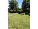Expansive backyard with mature trees and a well-maintained lawn at 5949 Flat Creek Rd, Kershaw, SC 29067