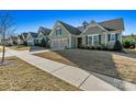 View of several homes in a neighborhood with well-maintained lawns and sidewalks at 7118 Overjoyed Xing, Charlotte, NC 28215