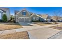 Charming single-story home featuring a well-manicured lawn and an attached two-car garage at 7118 Overjoyed Xing, Charlotte, NC 28215
