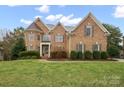 Elegant brick home with a lush green lawn and professionally landscaped front yard, perfect for curb appeal at 722 Fairway Point Dr, Fort Mill, SC 29708