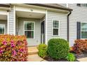 Inviting front porch entrance adorned with colorful foliage, leading to a cozy, well-maintained home at 730 Shuttles Way, Fort Mill, SC 29715