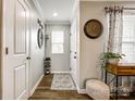 Bright hallway featuring hardwood floors, elegant decor, and access to multiple rooms at 730 Shuttles Way, Fort Mill, SC 29715