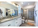 Modern bathroom featuring double sinks, a glass-enclosed shower, and neutral toned tile work at 8117 Jacey Ln # 42, Huntersville, NC 28078