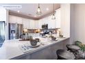 Contemporary kitchen with stainless steel appliances, white cabinetry, and a spacious countertop at 8117 Jacey Ln # 42, Huntersville, NC 28078