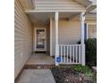 Inviting front porch with white pillars, showing the entrance to the home with a glass paneled front door at 8527 Conner Ridge Ln, Charlotte, NC 28269