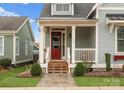 Inviting porch featuring a red door, white railing, and stone walkway, perfect for relaxing outdoors at 917 Herrons Ferry Rd, Rock Hill, SC 29730