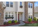 Inviting front entrance featuring stone accents, well-kept landscaping, and a neatly maintained walkway leading to the front door at 10129 Loch Lomond Dr, Charlotte, NC 28278