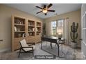 This is a virtual rendering of a home office space with neutral walls, a stylish desk, and built-in shelving at 10129 Loch Lomond Dr, Charlotte, NC 28278