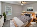 Cozy staged bedroom with a comfortable bed, soft lighting, and a view of the outdoors at 105 Southfork Ln, Belmont, NC 28012