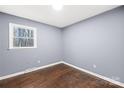 Bright bedroom featuring hardwood floors, a window with natural light, and gray painted walls at 1203 Northwoods Dr, Kings Mountain, NC 28086