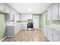 Bright kitchen featuring gray cabinets, stainless steel appliances, and a durable laminate floor at 1203 Northwoods Dr, Kings Mountain, NC 28086