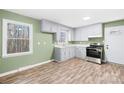 Cozy kitchen with gray cabinetry, modern appliances, and natural light from a large window at 1203 Northwoods Dr, Kings Mountain, NC 28086