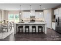 Bright, open kitchen featuring a large island with seating and modern stainless steel appliances at 1240 Cottage Green Dr # 0132, Monroe, NC 28112