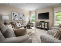 Comfortable living room with neutral tones, plush seating, and a large television at 1240 Cottage Green Dr # 0132, Monroe, NC 28112