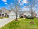 Inviting single-story home with manicured lawn, mature trees, and a charming facade at 134 Citation Dr, Mooresville, NC 28117