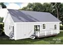 Back view of a charming home with a metal roof, and a deck, nestled in a green, grassy yard at 1473 32Nd Sw St, Hickory, NC 28602