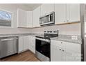 Bright kitchen with stainless steel appliances, granite countertops and white cabinetry at 167 Saluda St, Chester, SC 29706