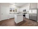 Modern kitchen featuring stainless steel appliances, an island, and ample cabinet space at 167 Saluda St, Chester, SC 29706