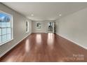 Spacious living room with hardwood floors and natural light from large windows at 2006 Durand Rd, Fort Mill, SC 29715