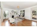 Bright living room with hardwood floors, large windows, fireplace, and neutral decor at 211 W 6Th Ave, Gastonia, NC 28052