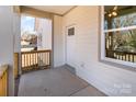 Cozy covered front porch with railings, front door, and window at 213 Shannonhouse W St, Shelby, NC 28152