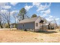 View of the home showing the backyard, light siding, and the foundation at 213 Shannonhouse W St, Shelby, NC 28152