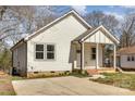 Charming home featuring white siding and a well-maintained front lawn at 220 Shannonhouse W St, Shelby, NC 28152