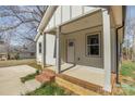 Inviting front porch featuring brick accents and covered columns at 220 Shannonhouse W St, Shelby, NC 28152