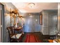 Elegant hallway with gray walls, a decorative light fixture, ornate mirror, and classic furnishings at 300 N Fulton St # 12, Salisbury, NC 28144