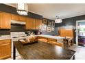 Cozy kitchen with dark accent wall, wood cabinets, and a rustic wooden island with an eating area at 300 N Fulton St # 12, Salisbury, NC 28144