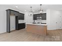 Modern kitchen featuring sleek black cabinets, stainless steel appliances, and a center island at 3030 Swallowtail Ln, Kannapolis, NC 28083