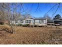 Cozy single-story home with a welcoming ramp and carport, nestled among trees for a tranquil and accessible living experience at 355 Branchwood Rd, Statesville, NC 28625