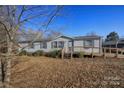 Inviting single-story home with a functional ramp and mature trees, offering easy access and a serene outdoor setting at 355 Branchwood Rd, Statesville, NC 28625