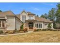Inviting front of house with a beautiful stone facade and manicured lawn at 4009 Beechwood Spring Ln, Belmont, NC 28012