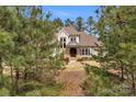 Charming home exterior framed by lush trees and mature landscaping at 4009 Beechwood Spring Ln, Belmont, NC 28012