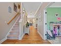 Inviting hallway with wood floors and staircase leading to the upper level of the home at 4035 W Sandy Trl, Fort Mill, SC 29707
