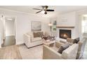 Cozy living room featuring a white brick fireplace and neutral decor at 4136 Woodgreen Ter, Charlotte, NC 28205