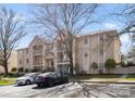 Exterior of multi-Gathering residential building surrounded by mature trees, and car parking at 6134 Meadow Rose Ln, Charlotte, NC 28215