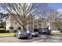 Residential multi-Gathering condo building with car parking and mature trees on a sunny day at 6134 Meadow Rose Ln, Charlotte, NC 28215