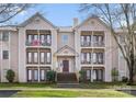 Multi-level condo with balconies, well-maintained landscaping, and brick stairway at 6142 Meadow Rose Ln, Charlotte, NC 28215