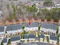 Overhead shot of the townhome with backyard, surrounding neighborhood, and nearby trees at 6936 Colonial Garden Dr, Huntersville, NC 28078